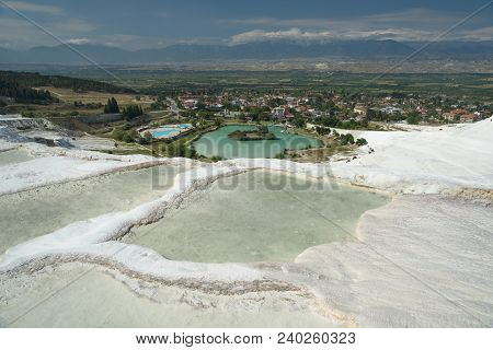 Limestone White Pamukkale Cascade In Foreground. Green Lake With Iseland In The Middle Of Compositio