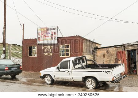 Pomeroy, South Africa - March 22, 2018: A Street Scene With A Hair Salon And Vehicles In Pomeroy In 