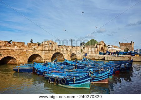 Fort Of Essaouira In Morocco On A Sunny Day With Blue Boats On The Water And Selective Focus