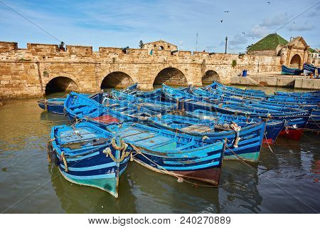 Fort Of Essaouira In Morocco On A Sunny Day With Blue Boats On The Water And Selective Focus