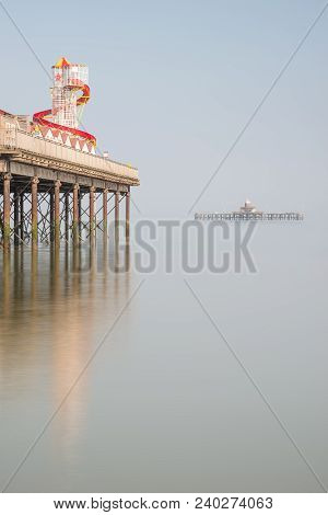 Minimalist Fine Art Image Of Colorful Pier In Juxtaposition With Old Derelict Pier In Background