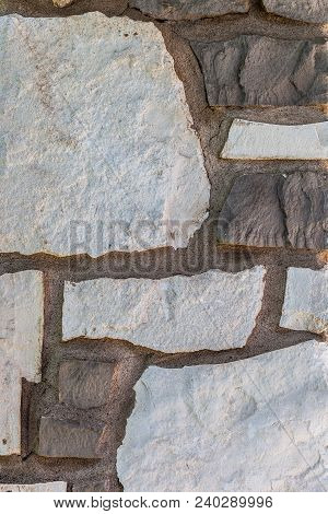 Background With Stone Wall With Irregular Sized White And Brown Slates