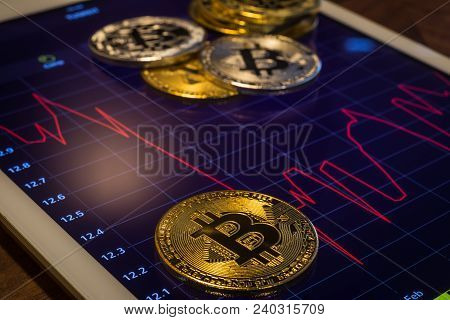 Cryptocurrency Gold Silver Metal, Focus On Bitcoin Sign, Coins Put On Modern Tablet Screen That Show