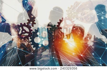 Teamwork Of Businesspeople Work Together And Combine Pieces Of Gears. Partnership And Integration Co