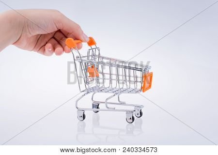 Hand Holding A Cart On A White Background