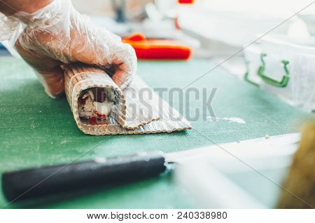 Professional Chef, Chef The Process Of Making Sushi Rolls, Spins Bamboo Mat And Cut Slices