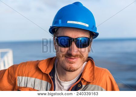 Happy Marine Deck Officer Or Chief Mate On Deck Of Vessel Or Ship , Wearing Ppe Personal Protective 