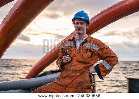Deck Officer On Deck Of Offshore Vessel Or Ship , Wearing Ppe Personal Protective Equipment. He Hold