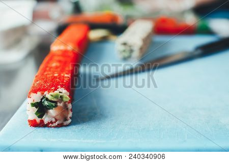Professional Chef, Chef The Process Of Making Sushi Rolls, Spins Bamboo Mat And Cut Slices