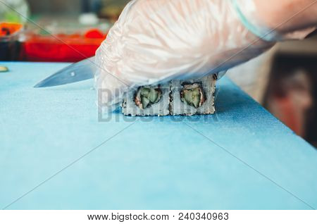 Professional Chef, Chef The Process Of Making Sushi Rolls, Spins Bamboo Mat And Cut Slices