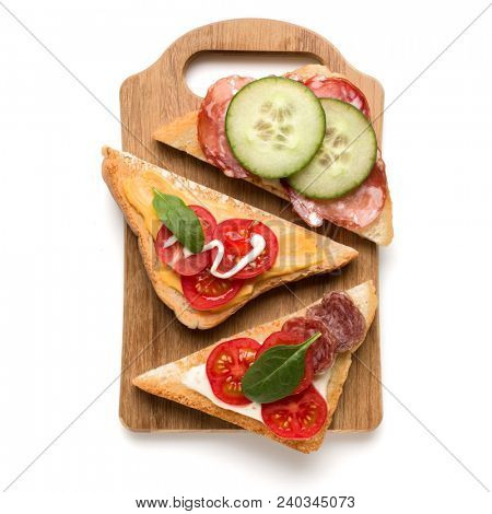 Open  faced sandwich canape or crostini on a wooden serving board  isolated on white background closeup. Top view.