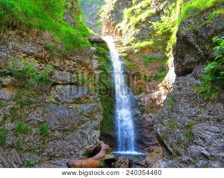 Grunau, Austria. Jun 14 2017: Flowing Waterfall To Calm Pool