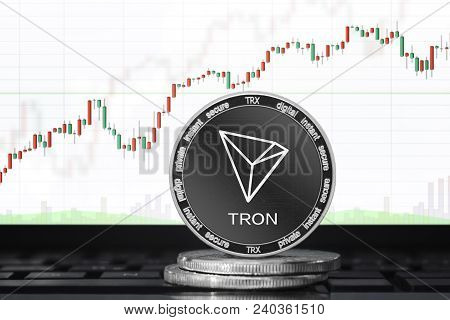 Tron (trx) Cryptocurrency; Physical Concept Tron (tronix) Coin On The Background Of The Chart