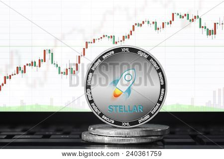Stellar (xml) Cryptocurrency; Physical Concept Stellar Coin On The Background Of The Chart