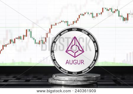 Augur (rep) Cryptocurrency; Physical Concept Augur Coin On The Background Of The Chart
