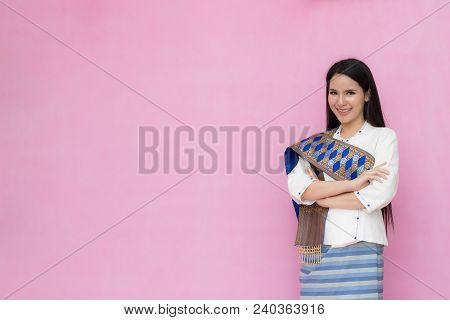 Portrait Beautiful Asian Girl In Traditional Thai Dress Isolated On Pink Background. .cotton Dress