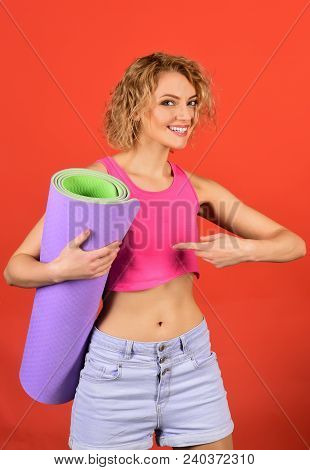 Health And Body Care, Sport Concept - Happy Fitness Woman Holds Yoga Mat And Shows Finger. Sports Wo