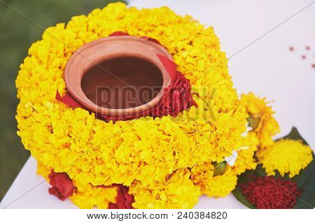 The Clay Pot Cover With Yellow Garland, The Prayer And Worship Items For Thread Ceremony, Pooja (puj