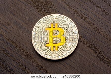 Brown Background With Golden Bitcoin On It. High Resolution Photo.