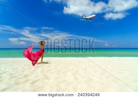 Woman with pink sarong on the tropical beach, Luxury beach travel vacation 