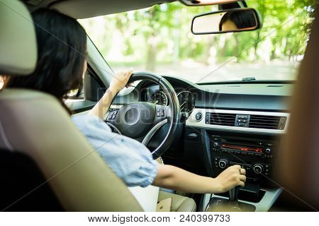 Elegant Young Woman Driving Confident A Car In City Enjoying The Traffic And Good Radio Station Musi