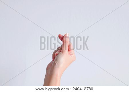 A Hand Signs Gesture To Be Little Heart From Tip Of Thumb And Index Finger On White Background.