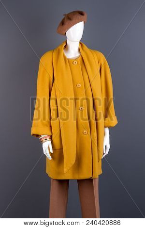 Women Fashionable Yellow Topcoat On Mannequin. Female Mannequin Wearing Stylish Autumn Outerwear, Gr