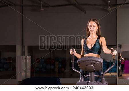 Sport, Fitness, Lifestyle And People Concept - Close Up Of Young Woman Flexing Muscles On Cable Gym 