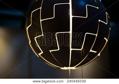 The Light Bulbs Are Shaped Like A Large Ball Hanging From The Ceiling.