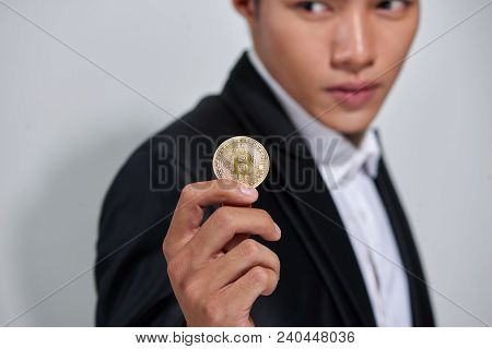 Golden Bitcoin In A Man Hand, Digitall Symbol Of A New Virtual Currency