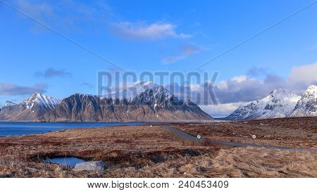 Lofoten Norwy, Long Road In Ramberg, With High Snow Top Mountains In The Background