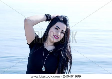 Happy Woman On The Beach. Portrait Of A Beautiful Girl Close-up. Spring Portrait On The Beach. Young