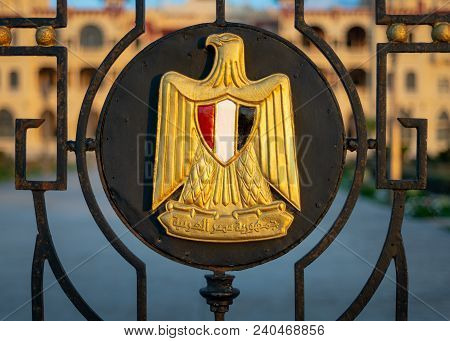 Logo, A Golden Eagle Of Saladin Holding A Scroll With Arabic Text (arab Republic Of Egypt) And A Shi