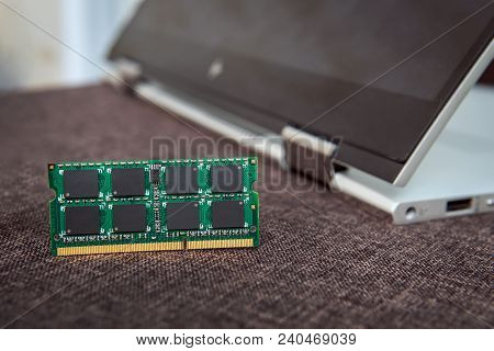 Memory Card Ram For Laptop On The Background Of A Laptop-transformer Folded Into A Tablet. Ddr For M