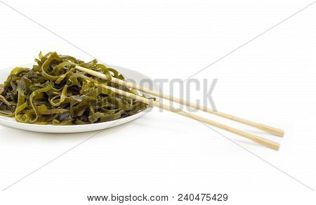 Fragment Of The White Dish With Salad Of Marinated Sliced Laminaria With Vegetable Oil And Spices An