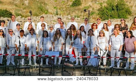 Malaga, Spain - May 12, 2018. Chorus Of People Singing Religious Songs In Front Of Roman Theater Alc