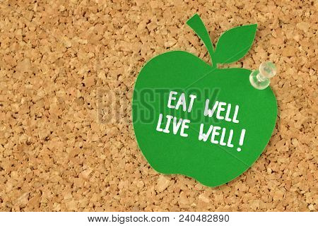 Eat Well, Live Well! Written On Apple Shaped Paper Note On Pinboard