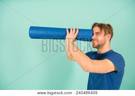 Man Spy In Yoga Mat As Telescope. Fashion Athlete In Blue Tshirt And Shorts. Sportsman With Stylish 