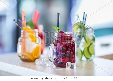Various Lemonades In Mason Jars With Orange Lime Lemon Otange Strawberries And Fresh Fruit Fruits