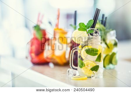 Various Lemonades In Mason Jars With Orange Lime Lemon Otange Strawberries And Fresh Fruit Fruits
