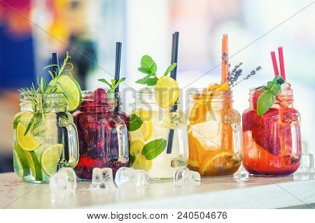 Various Lemonades In Mason Jars With Orange Lime Lemon Otange Strawberries And Fresh Fruit Fruits