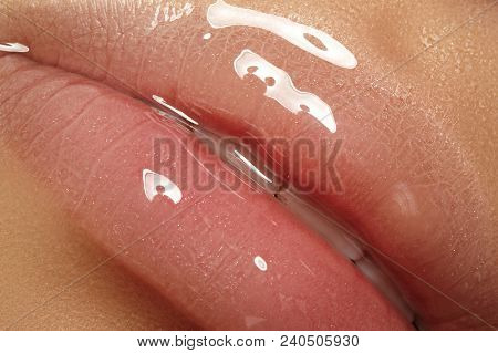 Moisturizing Lip Balm, Lipstick. Close-up Of A Beautiful Sexy Wet Lips. Full Lips With Gloss Makeup.