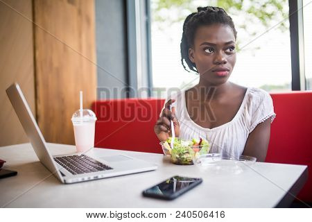 Beautiful Woman Have Lanch Eat Salad At Dinner Sitting At Cafe. Young African American Woman Sitting
