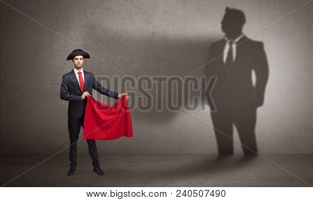 Businessman standing with red cloth on his hand and his shadow on the background