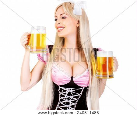 Young Beautiful Blond Oktoberfest Woman With Big Neckline On Female Breast Holds Two Mugs With Light