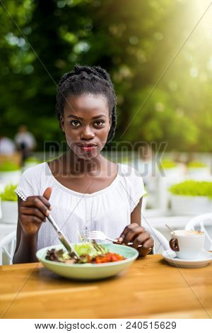 Young Afro American Woman Sitting In Street Cafe Outdoors Eat Fresh Salad