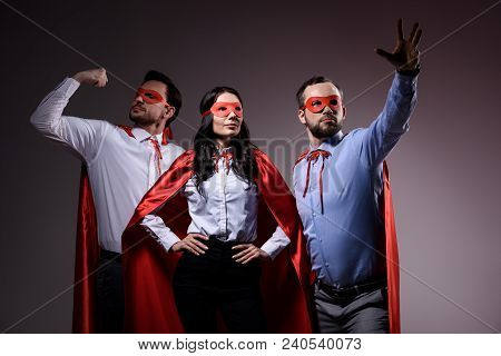 Super Businesspeople In Masks And Capes Showing Superpower Isolated On Grey