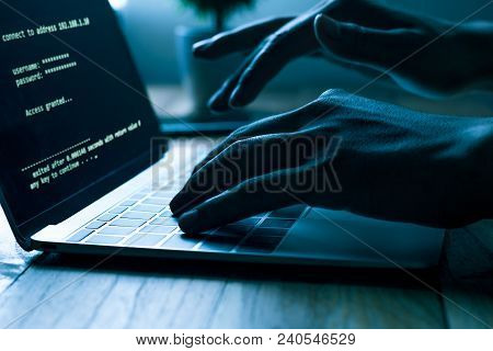 A Computer Programmer Or Hacker Prints A Code On A Laptop Keyboard To Break Into A Secret Organizati