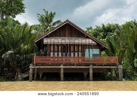 Traditional Riverside Wooden Thai House With Palm Farming Near Bang Pakong River, Chachoengsao, Thai
