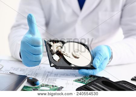 Male Repairman Wearing Blue Gloves Is Holding Hard Drive From Computer Laptop In Hands Show Ok Thumb